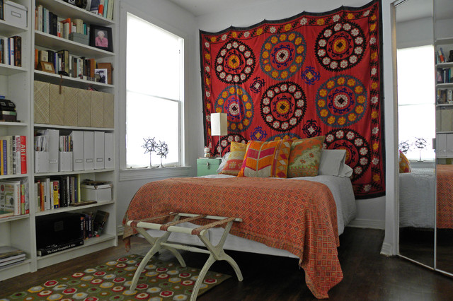 boho pillows and tapestry into small bedroom